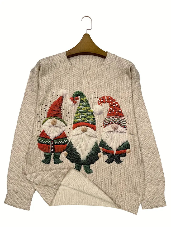 Beige sweater with embroidered gnomes on a hanger against a white background