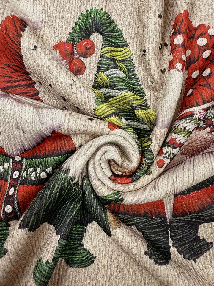 Close-up of a textured fabric with red, green, and beige patterns