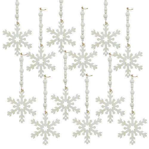 Decorative string with white snowflake ornaments and beads on a white background