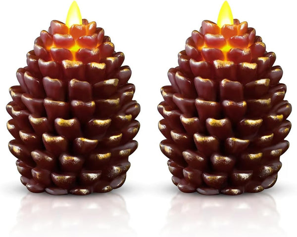 Two pine cone-shaped candles with glowing tops on a white background