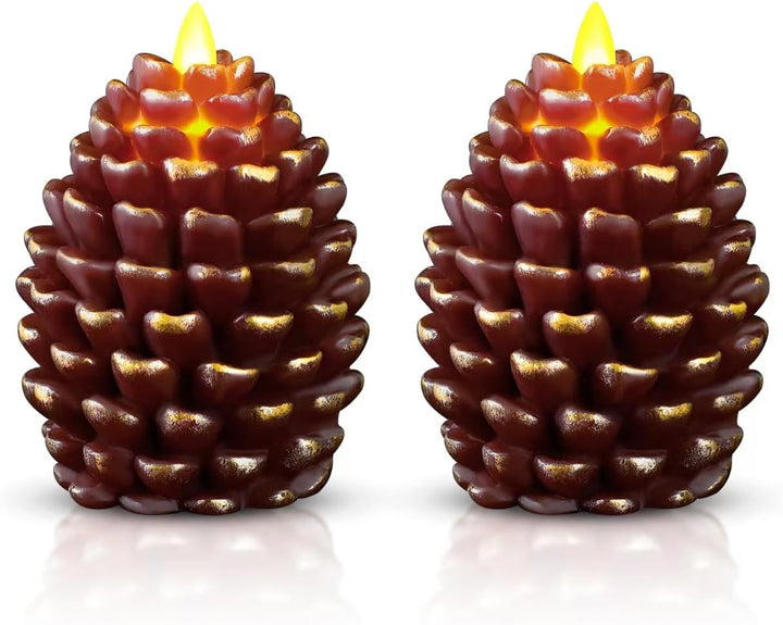 Two pine cone-shaped candles with glowing tops on a white background
