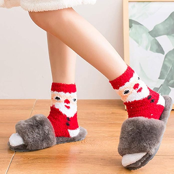 Person wearing Santa Claus-themed socks with gray slippers on a wooden floor.
