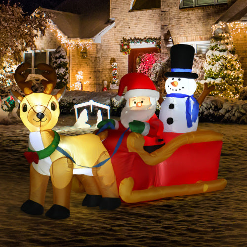 Inflatable Christmas scene with reindeer, Santa, and snowman on a sleigh