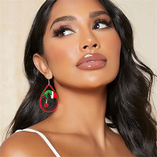 Woman wearing a unique earring with a red and green design on a beige background