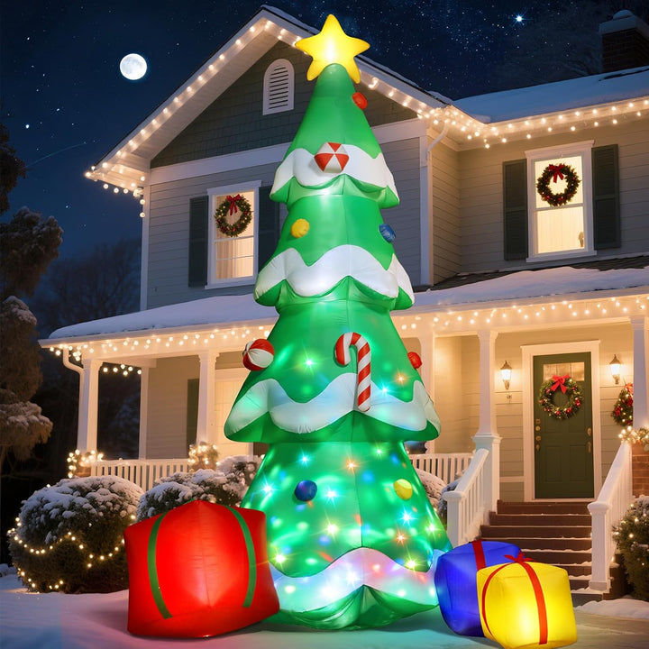 Inflatable Christmas tree with lights and decorations in front of a house decorated for Christmas.