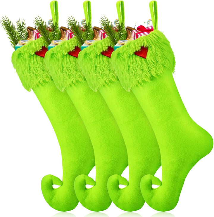 Set of grinch green Christmas stockings with tassels on a white background