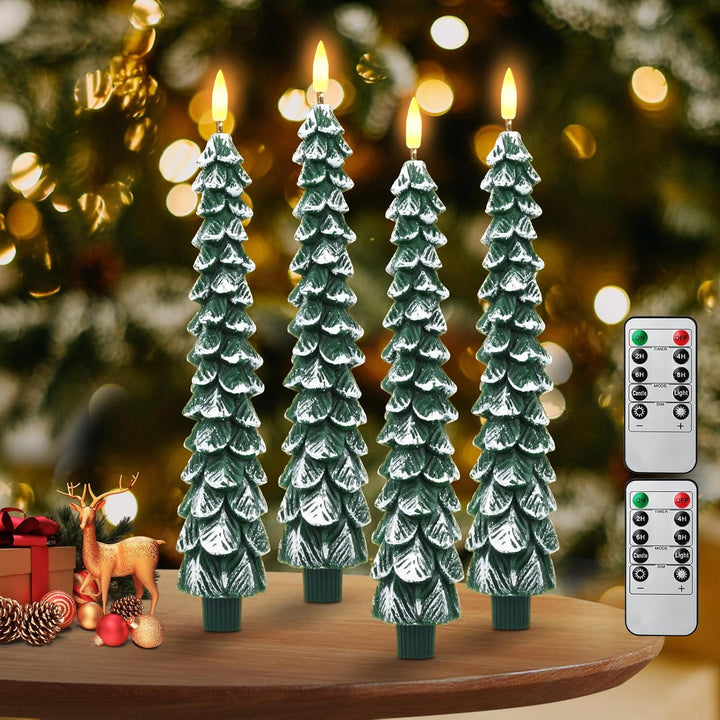 Set of four Christmas tree-shaped candles with a remote control on a wooden surface with a festive background.