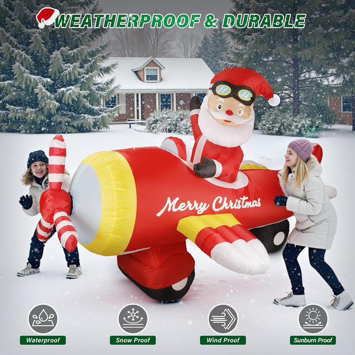 Inflatable Santa Claus on a Christmas airplane in a snowy outdoor setting with children playing.