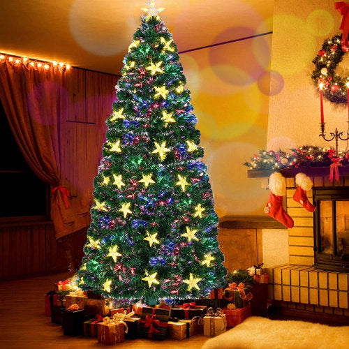 Decorated Christmas tree with colorful lights and presents in a festive room.