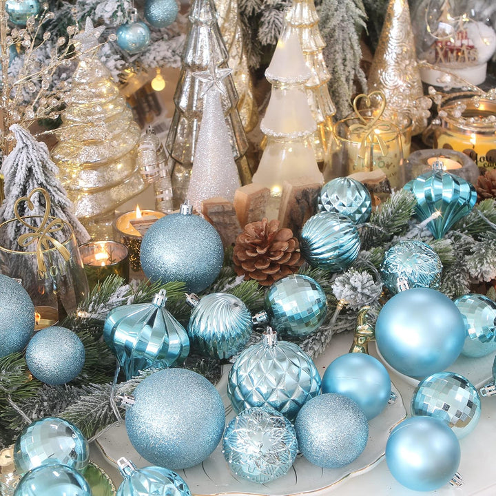 Decorative Christmas scene with blue ornaments, candles, and trees.