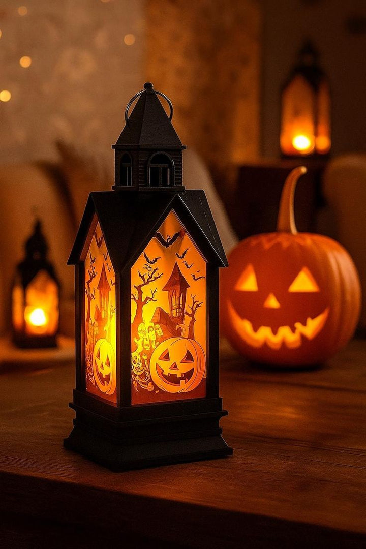 Halloween-themed lantern with carved pumpkins and a pumpkin in the background.